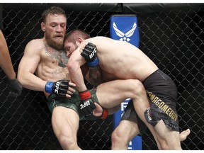 Khabib Nurmagomedov, right, tries to take down Conor McGregor during a lightweight title mixed martial arts bout at UFC 229 in Las Vegas, Saturday, Oct. 6, 2018.
