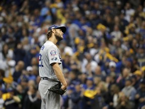 Dodgers starting pitcher Clayton Kershaw reacts after giving up a home run to Brewers' Brandon Woodruff during the third inning of Game 1 of the National League Championship Series in Milwaukee, Friday, Oct. 12, 2018.