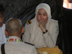 A relative of a passenger of a Lion Air plane cries while waiting for update on the plane that crashed off Java Island, at Tanjung Priok Port in Jakarta, Indonesia Monday, Oct. 29, 2018.
