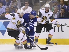 Toronto Maple Leafs' Morgan Rielly checks Vegas Golden Knights' William Karlsson during Tuesday night's game. (JACK BOLAND/Toronto Sun)