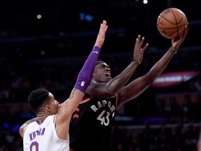 Raptors forward Pascal Siakam scores past Lakers' Kyle Kuzma during their game on Sunday. (GETTY IMAGES)