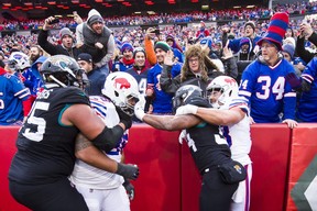 Carlos Hyde #34 of the Jacksonville Jaguars grabs the face mask of Star Lotulelei #98 of the Buffalo Bills as both teams scuffle during the third quarter at New Era Field on November 25, 2018 in Orchard Park, New York. Buffalo defeats Jacksonville 24-21.  (Photo by Brett Carlsen/Getty Images)