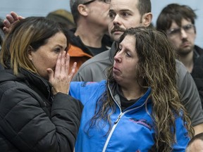 Lianna Hall gets a hug from co-worker Jenn Cowie before a Unifor Union meeting. Workers met with their union leaders after GM announced it would close up shop in Oshawa. (Craig Robertson, Toronto Sun)