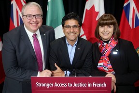 Attorney General Yasir Naqvi (centre) joined Marie-France Lalonde, Minister Responsible for Francophone Affairs, and François Boileau, French Language Services Commissioner, on Wednesda, October 11, 2017, at Ottawa City Hall. (Julie Oliver/Postmedia Network)
