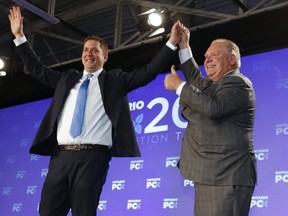 Federal Conservative leader Andrew Scheer is congratulated by Ontario Premier Doug Ford at the Ontario PC Convention 2018 held at the Toronto Congress Centre on Saturday November 17, 2018. (Jack Boland/Toronto Sun/Postmedia Network)