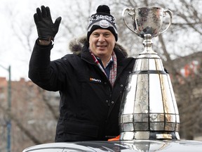 CFL commissioner Randy Ambrosie parades the Grey Cup around Edmonton yesterday.  
David Bloom/Postmedia Network