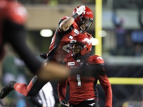 The Calgary Stampeders' Don Jackson (25) and Lemar Durant (1) celebrate Durant's touchdown during first half Grey Cup action against the Ottawa Redblacks at Commonwealth Stadium, in Edmonton Sunday November 25, 2018. Photo by David Bloom/Postmedia