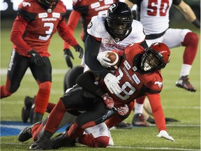 The Calgary Stampeders' Terry Williams is tackled by the Ottawa Redblacks' Chris Ackie during first half Grey Cup action at Commonwealth Stadium, in Edmonton Sunday, Nov. 25, 2018.