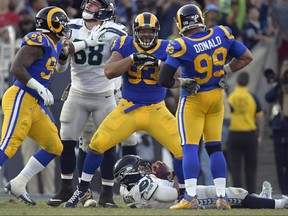 Los Angeles Rams nose tackle Ndamukong Suh (93) celebrates with defensive end Aaron Donald (99) after sacking Seattle Seahawks quarterback Russell Wilson during the second half in an NFL football game Sunday, Nov. 11, 2018, in Los Angeles. (AP Photo/Mark J. Terrill)