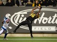 Hamilton Tiger-Cats wide receiver Bralon Addison makes a touchdown catch while defended by Montreal Alouettes defensive back T. J. Heath during the first half CFL game action in Hamilton, Ont. on Saturday, Nov. 3, 2018.