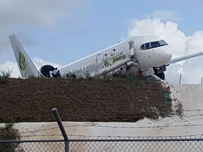 A Toronto-bound Fly Jamaica airplane is seen after crash-landing at the Cheddi Jagan International Airport in Georgetown, Guyana on November 9, 2018. - A Boeing jetliner carrying 126 people crash-landed at the airport in Guyana's capital Georgetown on Friday, injuring six people, the transport minister said.