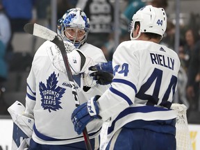 Maple Leafs goaltender Frederik Andersen is congratulated by Morgan Rielly after the team's 5-3 victory over the San Jose Sharks on Nov. 15. The pair have been a big part of the team's success at the 20-game mark of the season. (Tony Avelar/The Associated Press)
