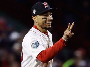 Boston Red Sox's Mookie Betts celebrates after Game 2 of the World Series baseball game against the Los Angeles Dodgers Wednesday, Oct. 24, 2018, in Boston.