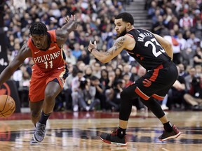 New Orleans Pelicans guard Jrue Holiday (11) drives around Toronto Raptors guard Fred VanVleet (23) during second half NBA basketball action in Toronto on Monday, November 12, 2018. THE CANADIAN PRESS/Nathan Denette ORG XMIT: NSD515