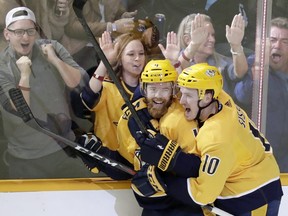 Nashville Predators defenceman Ryan Ellis (4) is congratulated by Colton Sissons (10) after Ellis scored a short-handed goal against the St. Louis Blues in the third period of an NHL hockey game Wednesday, Nov. 21, 2018, in Nashville, Tenn. The Predators won 4-1. (AP Photo/Mark Humphrey)