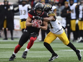 Hamilton Tiger-Cats' Frankie Williams (37) tackles Ottawa Redblacks' Julian Feoli-Gudino (83) during first-half CFL East Division Final football game action in Ottawa, Sunday, Nov. 18, 2018. (Justin Tang/The Canadian Press via AP)