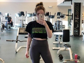MacKenzie Parsons poses in this gym selfie at St. Thomas University in Fredericton in this recent handout photo. A Fredericton student who was told that the crop top she wore to a campus gym was too distracting, will get an apology from St. Thomas University. MacKenzie Parsons says she was embarrassed and shocked when a male student, who was working at the gym, warned her that there was a policy being developed that would not allow crop tops. The 21-year-old took to social media to complain, and noted that male students often went shirtless or wore muscle shirts that were ripped down the sides.