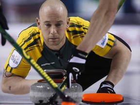 Northern Ontario third Ryan Fry makes a shot as his team plays Newfoundland and Labrador during curling action at the Brier in Calgary, Thursday, March 5, 2015. A curling team skipped by Jamie Koe of the Northwest Territories which included Olympic gold medal winner Ryan Fry has been ejected from a big Alberta bonspiel for what organizers call unsportsmanlike behaviour resulting from public drunkenness.