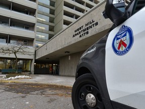Toronto police attend the scene of Sunday's shooting death inside an apartment building at 4175 Lawrence Ave. (Bryan Passifiume/Toronto Sun)