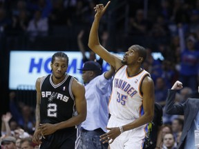 Kawhi Leonard (left) and Kevin Durant go head-to-head during their time with the Spurs 
and Thunder, respectively, back in 2013. Leonard, now a star with the Raptors, and Durant, 
a game-changer with the Warriors, will meet again tonight in Toronto. AP FILE