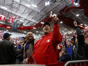 Joe Taylor of Indianapolis, calls journalists "fake news" during a campaign rally with President Donald Trump at Southport High School, Friday, Nov. 2, 2018, in Indianapolis. (AP Photo/Evan Vucci)