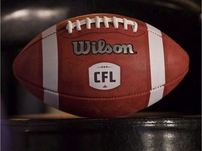A football with the new CFL logo sits on a chair during a press conference in Winnipeg, Friday, November 27, 2015. The CFL playoffs begin Sunday and Matt Black figures it's only fitting the road to the Grey Cup begins on the same day Canada remembers those who've made the ultimate sacrifice for this country.
