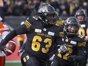 Hamilton Tiger-Cats lineman Kelvin Palmer (63) celebrates his fumble recovery touchdown during first half CFL Football division semifinal game action against the B.C. Lions in Hamilton, Ont. on Sunday, November 11, 2018. THE CANADIAN PRESS/Peter Power