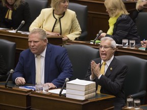 Vic Fedeli rises in the legislature at Queen's Park this afternoon, to read the Economic Outlook For Ontario, as his fellow MPPs wear yellow to show their support for him. Toronto, Ont. on Thursday November 15, 2018. (Stan Behal/Toronto Sun/Postmedia Network)