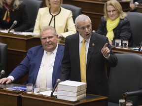 Vic Fedeli rises in the legislature at Queen's Park this afternoon, to read the Economic Outlook For Ontario, as his fellow MPPs wear yellow to show their support for him. Toronto, Ont. on Thursday November 15, 2018. (Stan Behal/Toronto Sun/Postmedia Network)