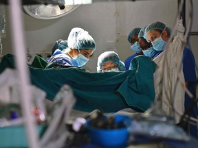Gynecological surgeon Dr. Marci Bowers (centre) begins the process of clitoral restorative surgery on a woman in Nairobi, Kenya on May 11, 2017.