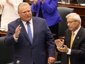 Premier Doug Ford speaks beside Ontario Finance Minister Vic Fedeli during question period after announcing his government will seek to create a select committee to investigate Liberal waste and scandal at Queen's Park in Toronto, Ont. on September 24, 2018. Dave Abel/Toronto Sun