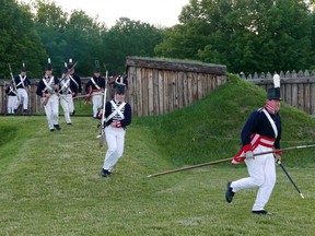 American soldiers storm Fort George in a re-enactment of the Battle of Fort George, a pivotal event during the War of 1812. (Fred Mercnik/Postmedia)