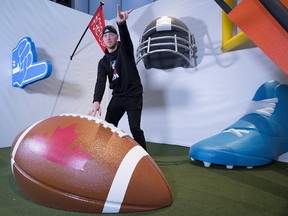 Calgary Stampeders quarterback Bo Levi Mitchell (19) jokes around in the Instagram booth during Grey Cup media day in Edmonton, Thursday, Nov. 22, 2018. (THE CANADIAN PRESS/Jonathan Hayward)