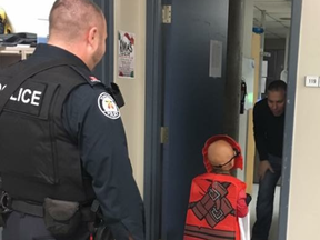 Toronto Police officers and civilians working at 31 Division in North York ensured a young boy didn't miss out on Halloween by taking him trick-or-treating around the police station on Wednesday, Oct. 31, 2018. (Facebook)