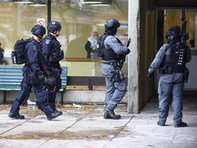 Heavily armed Toronto Police tactical officers attend a deadly shooting inside a TCHC apartment building at 4175 Lawrence Ave. in West Hill on Sunday, Nov. 18, 2018.