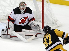 Devils goaltender Keith Kinkaid stops a shot by Penguins' Sidney Crosby in the third period of an NHL game in Pittsburgh, Nov. 5, 2018.