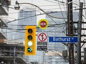 Signage at Bathurst St. and King St. W. for the King Street Pilot Project on Monday November 13, 2017.