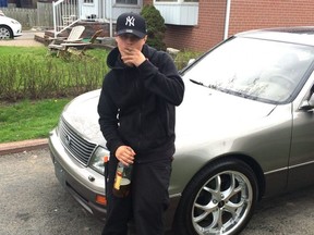 In a court exhibit photo, Jonathan Landsberg is pictured wearing the orange-tipped knife he used to kill 18-year-old Francesco Molinaro during a street fight in Wasaga Beach.