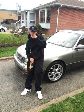 Jonathan Landsberg, wearing the orange-tipped knife he used to kill 18-year-old Francesco Molinaro during a street fight in Wasaga Beach. (Court photo)
