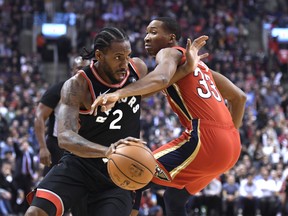 Raptors forward Kawhi Leonard (left) drives around New Orleans Pelicans forward Wesley Johnson on Monday night at Scotiabank Arena. (Nathan Denette/The Canadian Press)