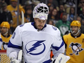 Tampa Bay Lightning goaltender Louis Domingue takes a timeout during the second period of the team's NHL hockey game against the Pittsburgh Penguins in Pittsburgh, Thursday, Nov. 15, 2018. The Lightning won 4-3. (AP Photo/Gene J. Puskar)