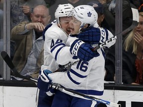 Toronto Maple Leafs defenceman Morgan Rielly, left, celebrates his goal with right wing Mitchell Marner scoring during overtime in an NHL hockey game against the Anaheim Ducks in Anaheim, Calif., Friday, Nov. 16, 2018. The Maple Leafs won 2-1. (AP Photo/Alex Gallardo)