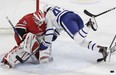 Toronto Maple Leafs' Nazem Kadri falls against Carolina Hurricanes goalie Curtis McElhinney (35) during the second period of an NHL hockey game in Raleigh, N.C., Wednesday, Nov. 21, 2018. (AP Photo/Gerry Broome)
