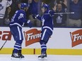 Maple Leafs John Tavares (left)  celebrates his goal with teammate Mitch Marner against Columbus on Monday. VERONICA HENRI/TORONTO SUN
