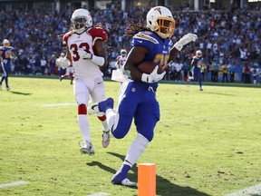 Chargers running back Melvin Gordon (right) scores a touchdown against the Cardinals at the StubHub Center in Carson, California, on Sunday, Nov. 25, 2018.