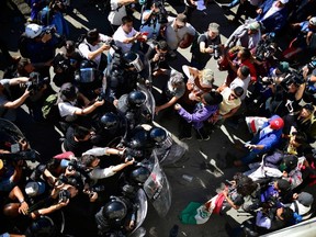 Aerial view of Central American migrants trying to reach the United States in hopes of a better life, being stopped by federal police officers near El Chaparral port of entry on the US-Mexico border, in Tijuana, Baja California State, Mexico on Sunday, Nov. 25, 2018.