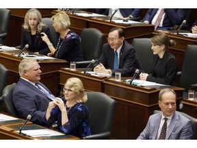 PC MPP Amanda Simard, second row right, is seen seated amongst fellow MPP’s and Ontario Premier Doug Ford, left, as the legislature sits inside Queens Park in Toronto on September 15, 2018. (Cole Burston/The Canadian Press)