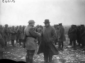 Prime Minister Sir Robert Borden visits the Western Front. Hon.Bob Rogers meets an old friend. March, 1917.