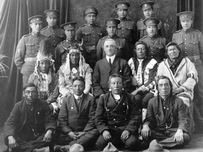 Recruits from File Hills, Saskatchewan pose with elders and a government representative in a 1915 photo from the Saskatchewan Provincial Archives Collection.