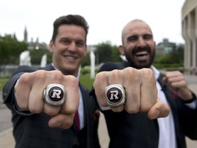 Redblacks’ Greg Ellingson (left) and Brad Sinopoli show off the Grey Cup rings they won after beating Calgary in 2016. THE CANADIAN PRESS FILE